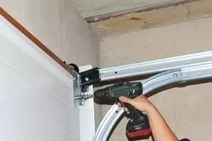 Contractor Installing Garage Door. Contractor Installing Garage Door.