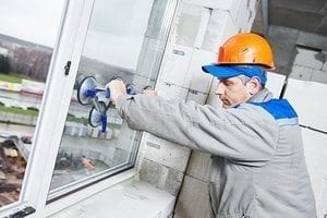 male industrial builder worker at window installation in building construction site